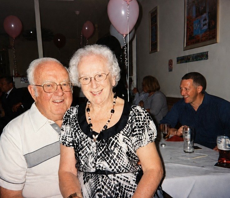 An elderly couple at a celebration, restored with natural colour