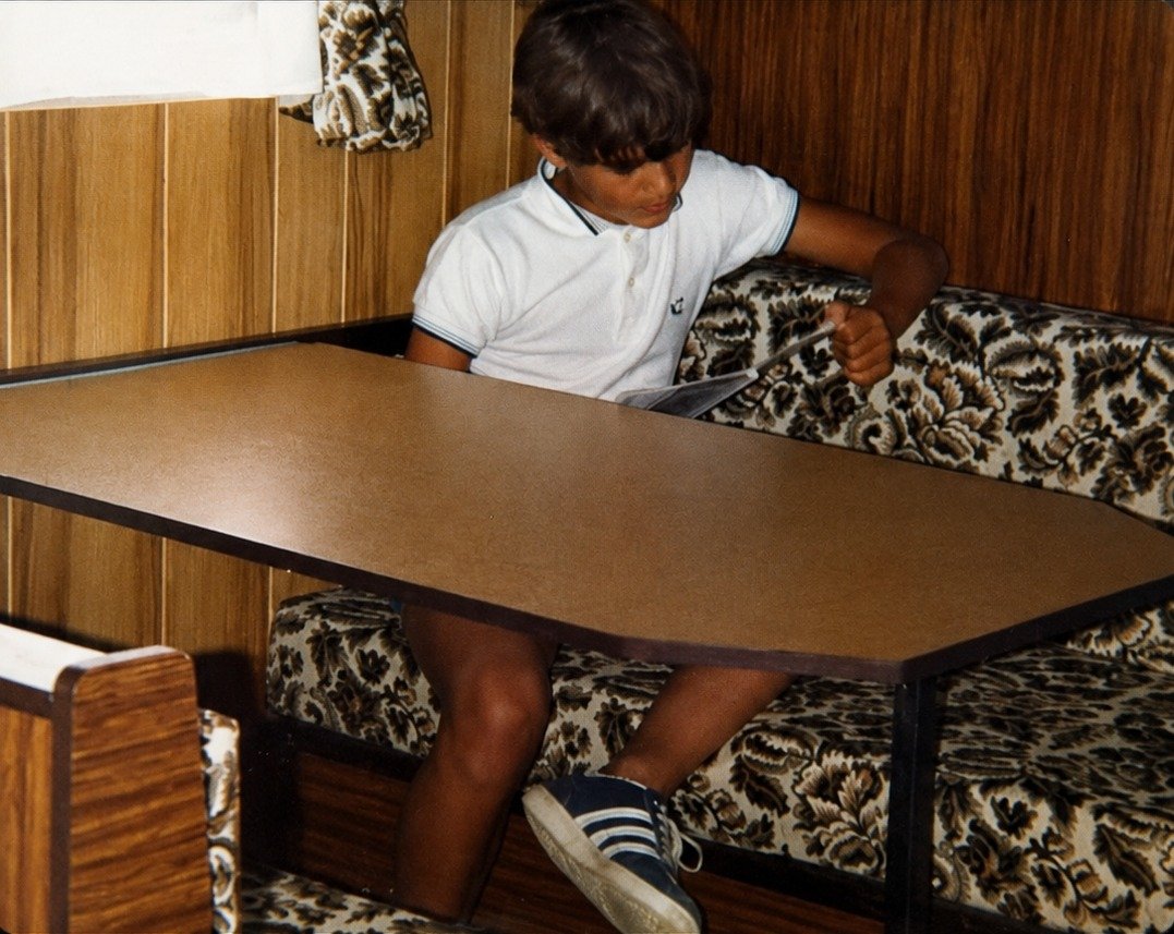 Boy at a caravan table, restored and enhanced